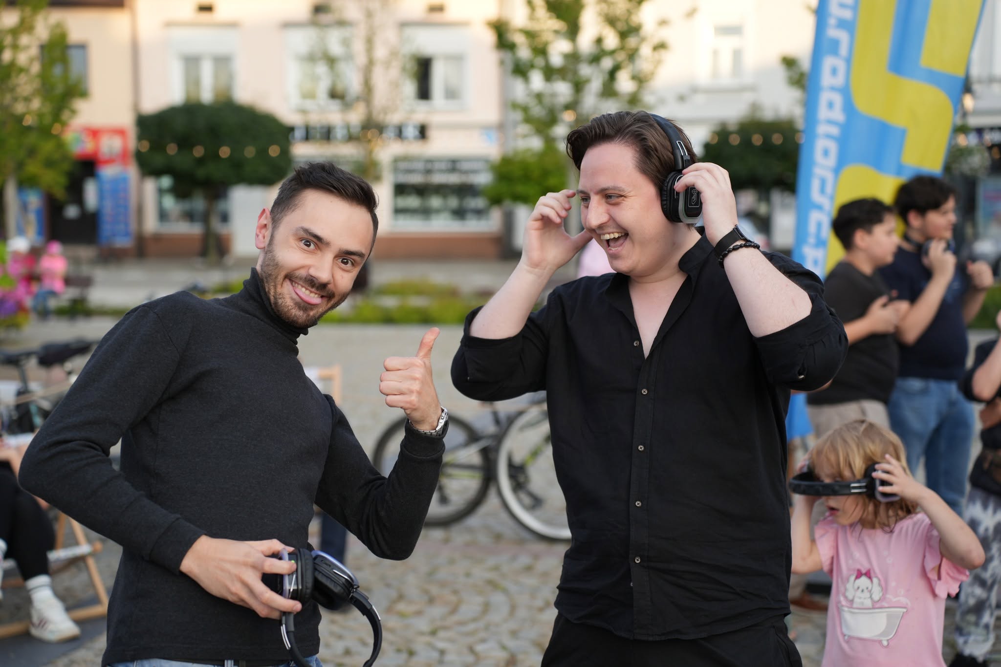 Artyści przy stoisku DJ z dużą sceną i słuchawkami